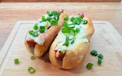 Dwa pyszne hot dogi z piekarnika z serem i szczypiorkiem. Idealne na szybki lunch z frytkownicy powietrznej.