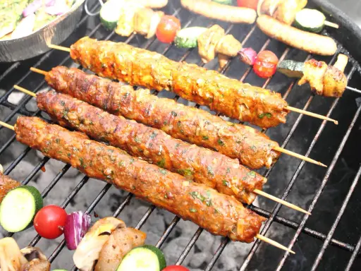 Aromatyczne mięso mielone na grilla, w towarzystwie warzyw, nabiera apetycznego koloru.